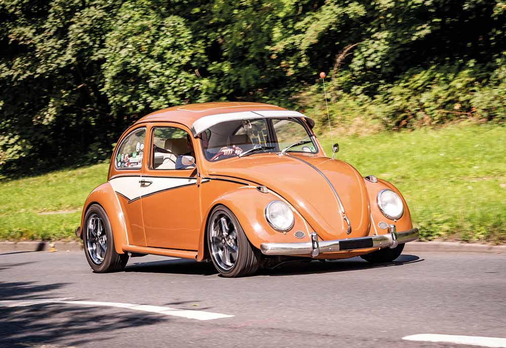 Orange VW Beetle driving down UK road