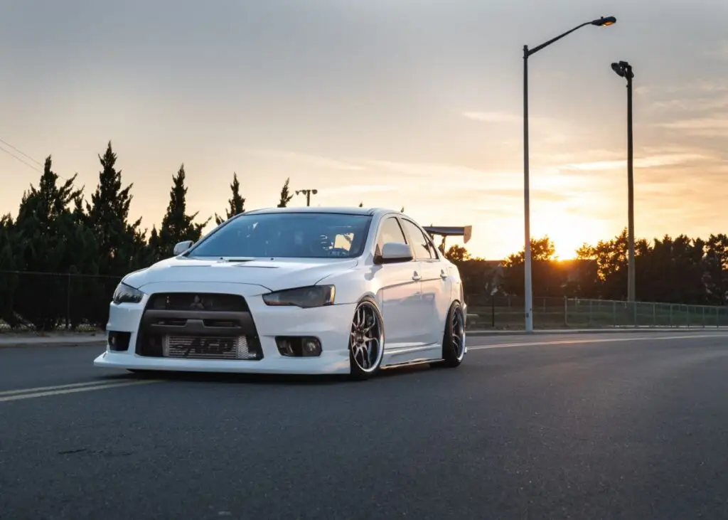 Mitsubishi Lancer Evolution driving down a road